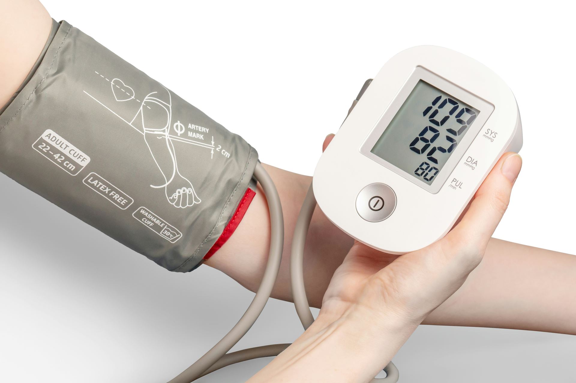 a person holding a blood pressure monitor in their hand and wearing a cuff