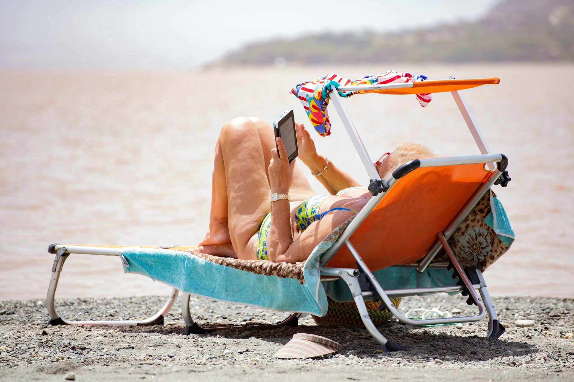 a man relaxing on a recliner on the beach