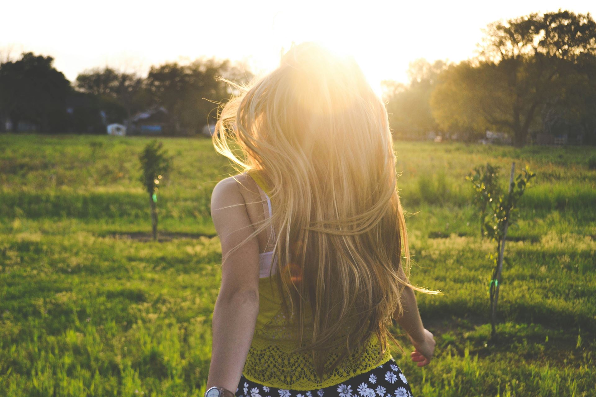 a woman walking into the sunset